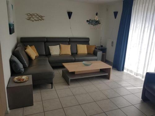 a living room with a couch and a coffee table at Lovely bungalow with garden in Breskens