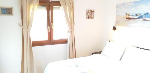 a bedroom with a bed and a window at Barbagiannis House in Ormos Panagias