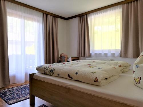 A bed or beds in a room at Apartment in Mayrhofen with a balcony