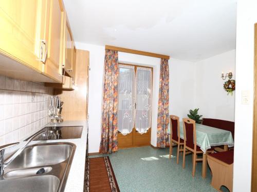 A kitchen or kitchenette at Apartment in Mayrhofen with a balcony