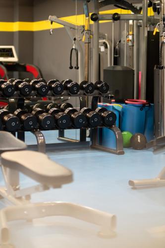 a rack filled with lots of dumbbells in a gym at Avec Hotel in Canakkale