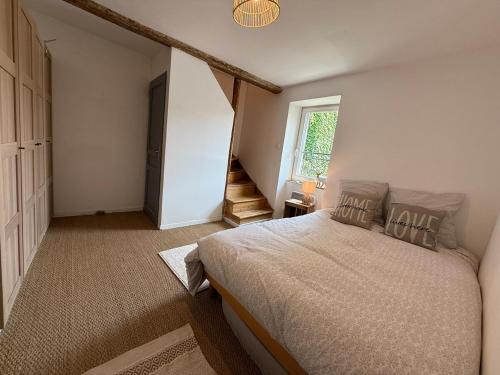 - une chambre avec un lit et un escalier avec une fenêtre dans l'établissement L'Hedera - proche Zenith & Calme, à Pérignat-lès-Sarliève