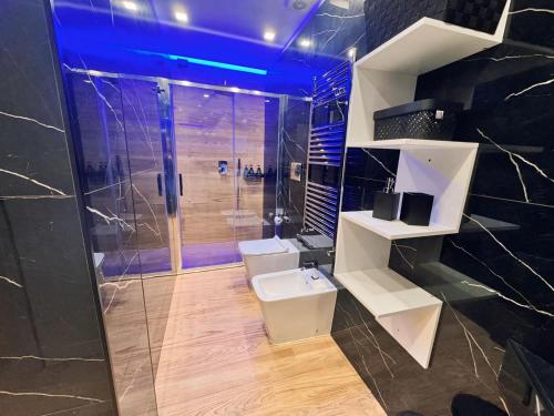 a bathroom with a shower and a sink and a toilet at HOLIDAYS HOMES ROME GOLF Appartamenti Marco Simone AeB in Marco Simone