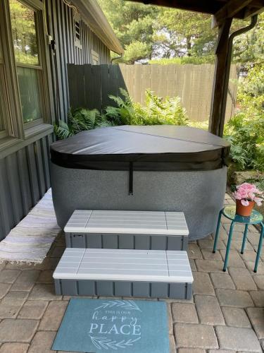 a hot tub sitting on a patio with a table at Deer Creek Winery at Watson Estate in Uniontown