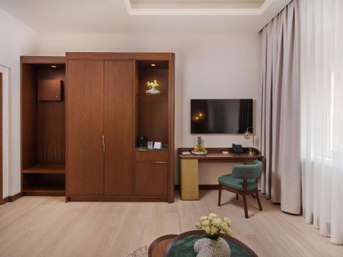 a room with a desk and a cabinet with a television at Palazzo President in Split
