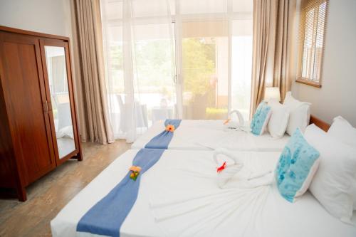 Ένα ή περισσότερα κρεβάτια σε δωμάτιο στο Macmillan's Holiday Villas