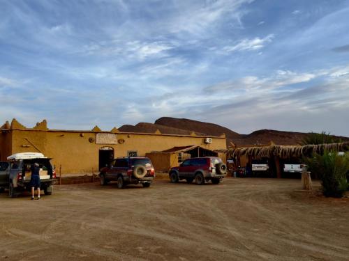 a group of cars parked in front of a building at Auberge Dar Lajdoud in Tafraoute Sidi Ali