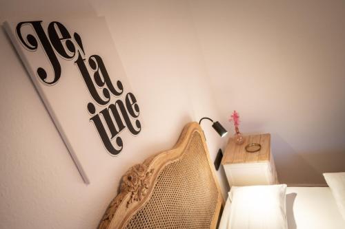 a bedroom with a bed and a sign on the wall at Engel 16 in Gutach