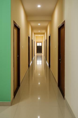 an empty corridor of a building with doors at Sundaram Rooms in Coimbatore