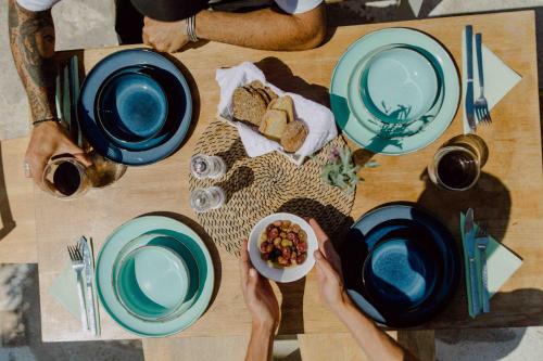 a table with blue plates and a bowl of food at Samothraki Village Hotel in Palaiopoli