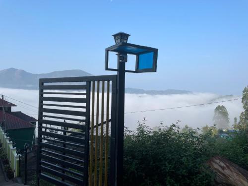 a street light with a view of the mountains at Mountain cheers munnar in Munnar