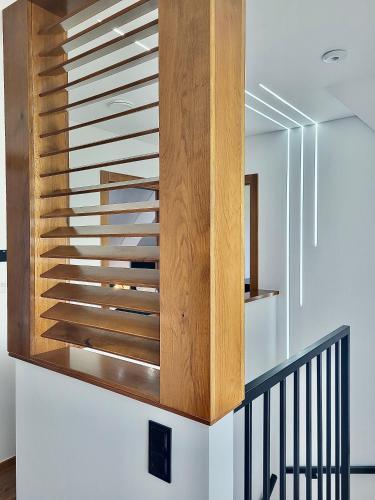 a wooden staircase in a house at Na Skraju Lasu Szlembark in Szlembark