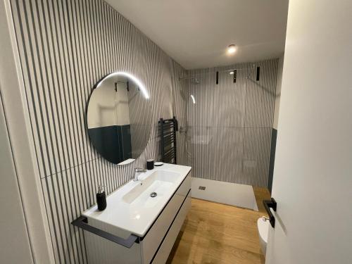 a bathroom with a sink and a mirror at Residence Mirabel in Tignale