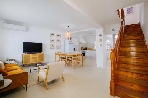a living room with a couch and a table at Vila Gorila - Coastal Home in Porto Formoso