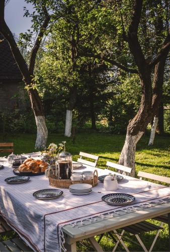 a picnic table with plates and food on it at Wietorówka in Lubomierz