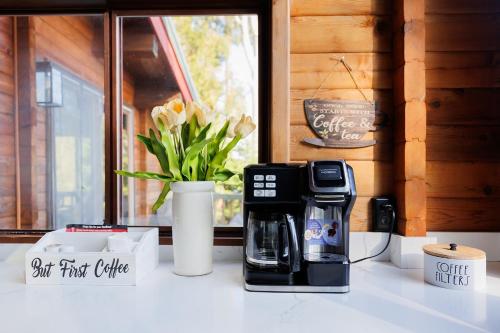 a coffee maker and a coffeemaker sitting on a counter at Port Hadlock Luxury Cabin Retreat Awaits you! cabin in Chimacum