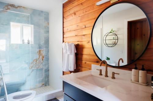 a bathroom with a sink and a mirror at Port Hadlock Luxury Cabin Retreat Awaits you! cabin in Chimacum