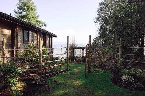 a wooden gate in front of a house at Port Hadlock Luxury Cabin Retreat Awaits you! cabin in Chimacum