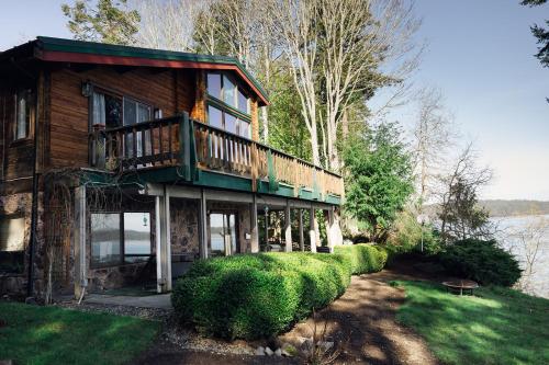 a house with a balcony on the side of it at Port Hadlock Luxury Cabin Retreat Awaits you! cabin in Chimacum