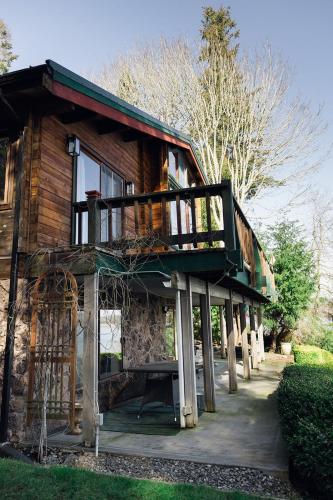 a house with a balcony on the side of it at Port Hadlock Luxury Cabin Retreat Awaits you! cabin in Chimacum
