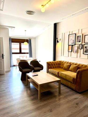 a living room with a couch and a coffee table at Barbarossa Suites Plaza de España in Merida