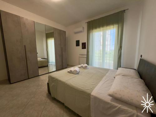 Un dormitorio con una cama grande y un espejo grande. en Villa Arya by Madreperla, en Taranto