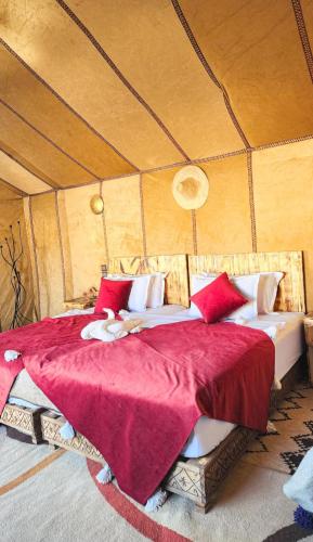a bedroom with a large bed in a tent at Najma Luxury Camp in Merzouga
