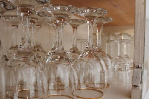 a bunch of wine glasses sitting on a shelf at La Casa d'Opale, maison de vacances 14 couchages in Montauban