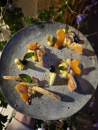 a plate of food on a table at Hôtel-Chalet les Mélèzes in Valloire