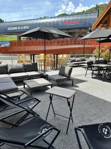 a group of chairs and tables in front of a stadium at Hôtel-Chalet les Mélèzes in Valloire
