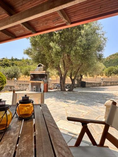 a wooden picnic table sitting on a patio at The Big Olive Tree in Hanioti
