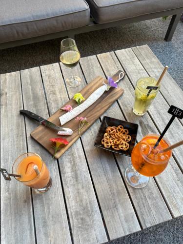 a wooden table with food and drinks on it at Hôtel-Chalet les Mélèzes in Valloire
