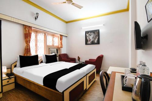 a bedroom with a large bed in a room at Hotel O Salt lake City in Kolkata
