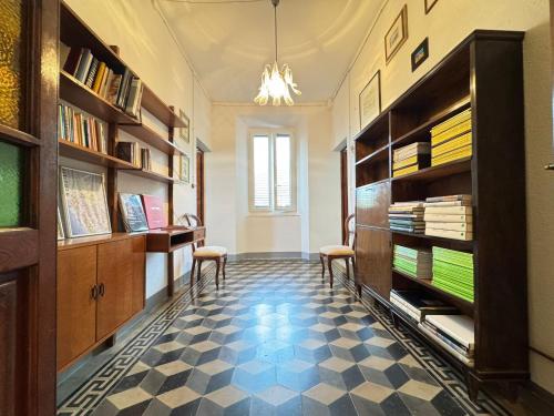 a room with two chairs and book shelves at casa vacanze La Versilia in Vallecchia