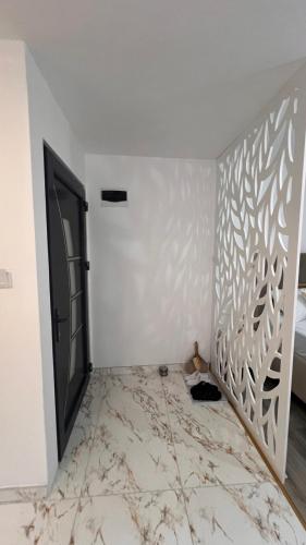 a room with a white wall with a patterned wall at White house Paradise in Bihać