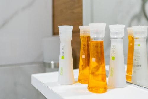 a group of four bottles of honey on a counter at ROCAS Hotel in Orhei