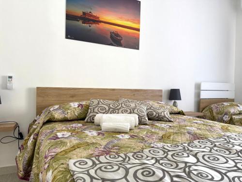 a bedroom with a large bed with at Maison du port 2 in Civitavecchia