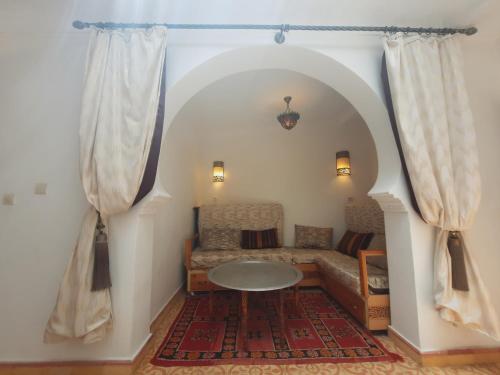 a living room with a couch and a table at DAR Dunia Panoramic terrace in Chefchaouene