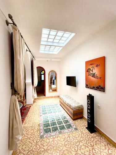 a living room with a bed and a skylight at DAR Dunia Panoramic terrace in Chefchaouene
