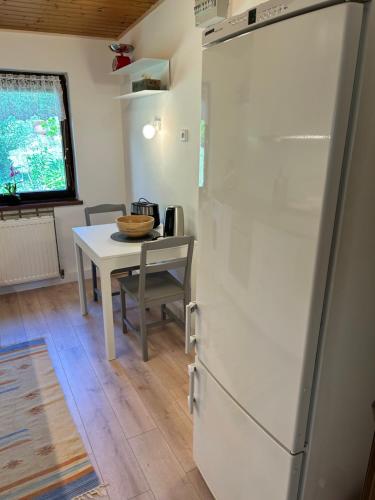 a kitchen with a white refrigerator and a table at Haus Ingrid in Mauerbach