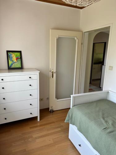 a bedroom with a bed and a dresser and a mirror at Haus Ingrid in Mauerbach