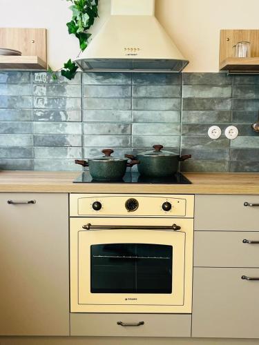 a kitchen with two pots on top of a stove at Ntiniakos House in Plomarion