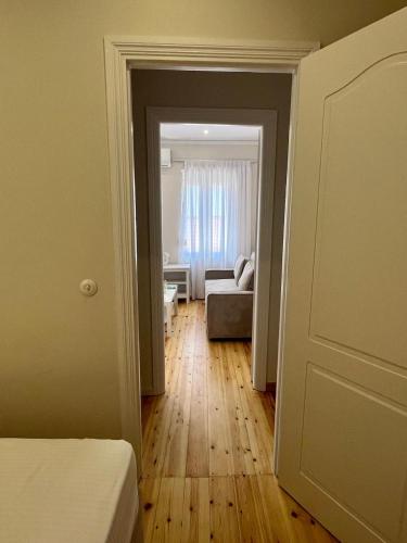 a room with a bed and a living room at Ntiniakos House in Plomarion