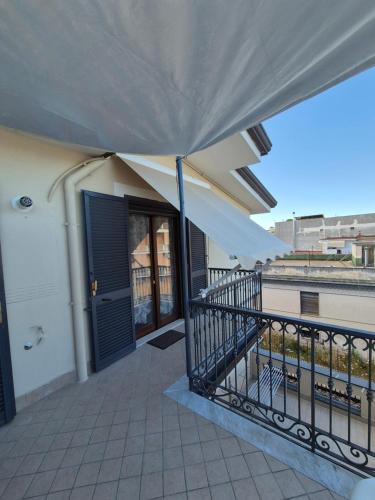 a balcony with a blue door and a fence at A casa di Matilde in Terzigno