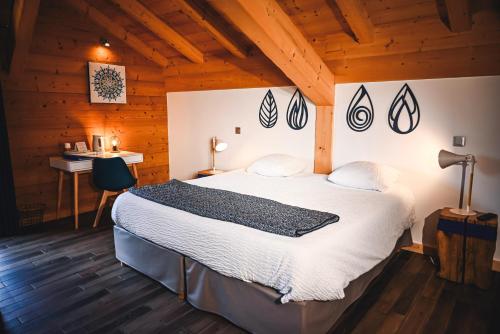 a bedroom with a bed in a wooden cabin at Le Marie Lydie - Chambre d'hôte in La Chapelle-dʼAbondance