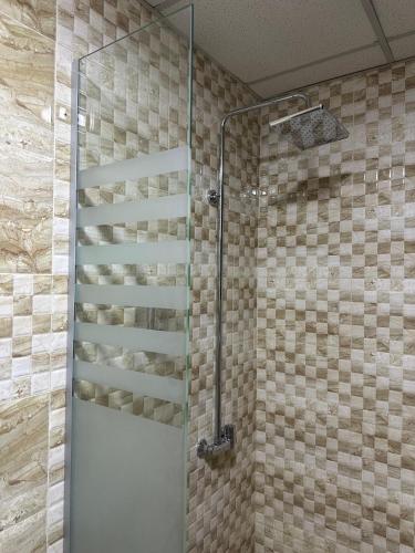 a shower with a glass door in a bathroom at Eden Hotel in Aqaba