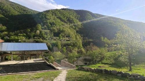 a view of a mountain with a building in the foreground at Arabachyan guest house in Aygut