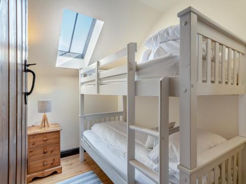 a bunk bed room with two bunk beds and a window at The Dairy in Beck Hole