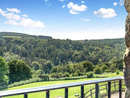 a view from a balcony of a field and trees at The Dairy in Beck Hole