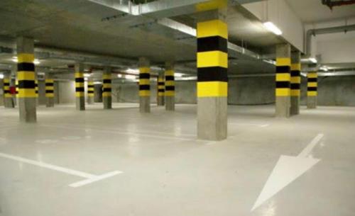 an empty parking garage with yellow and black poles at Hanza Tower BOHEMIA 23 Pool & Jacussi & Sauna in Szczecin